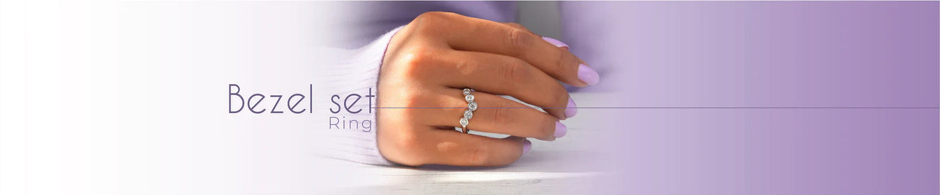 Model wearing bezel set engagement ring on her right hand, showcasing ring's beauty and sparkling round diamonds half bezel set. 