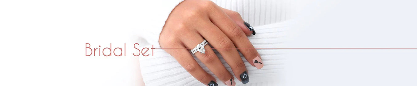 model hand view showcasing pear cut soltiare accent bridal set. also avialable in round, oval,and emerald shapes diamond