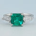 front view of asscher cut green gemstone with bullet diamond 3 stone wedding ring