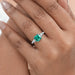 asscher cut green gemstone with bullet diamond 3 stone wedding ring on model's finger