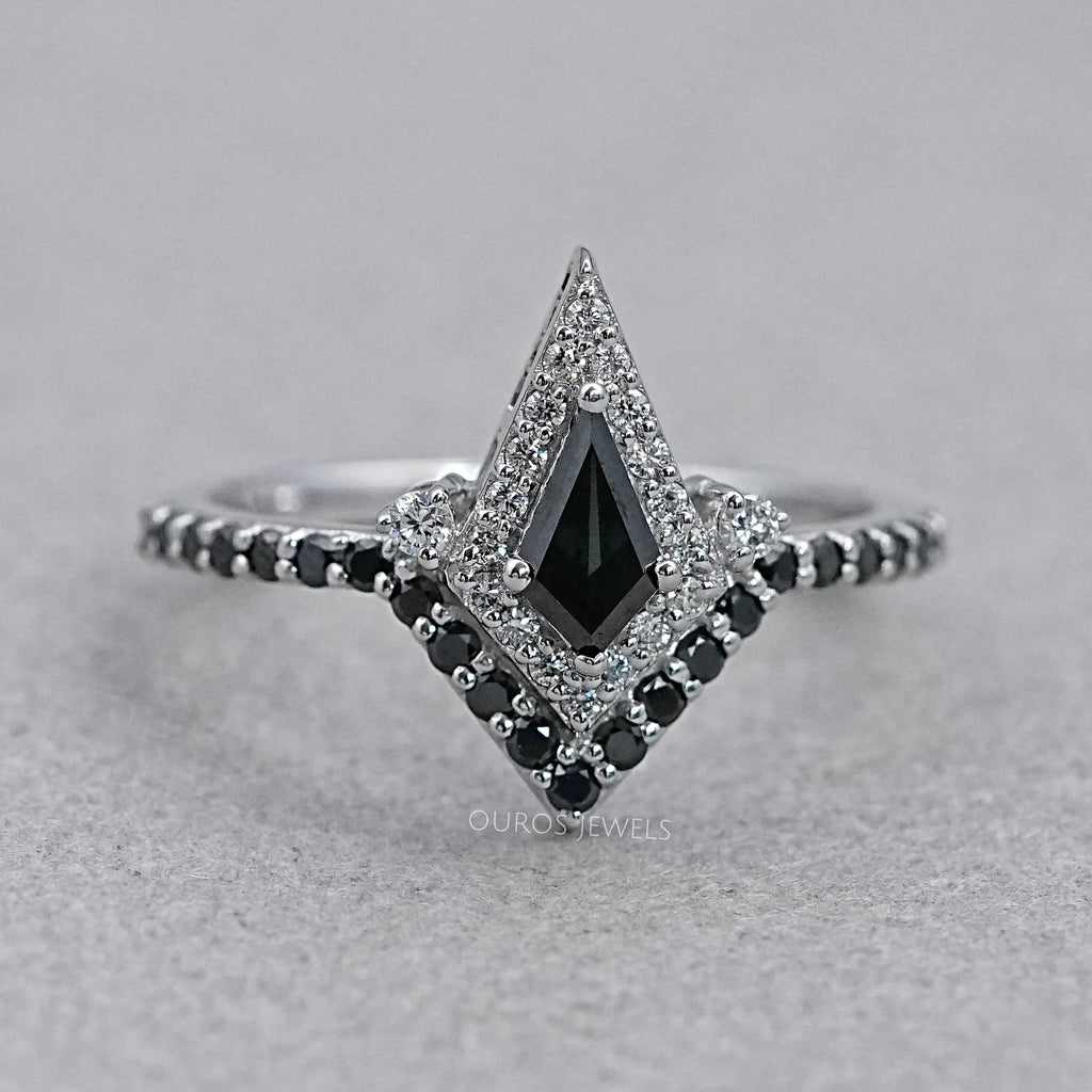 front view of black kite-cut lab diamond curved halo wedding ring on grey fabric