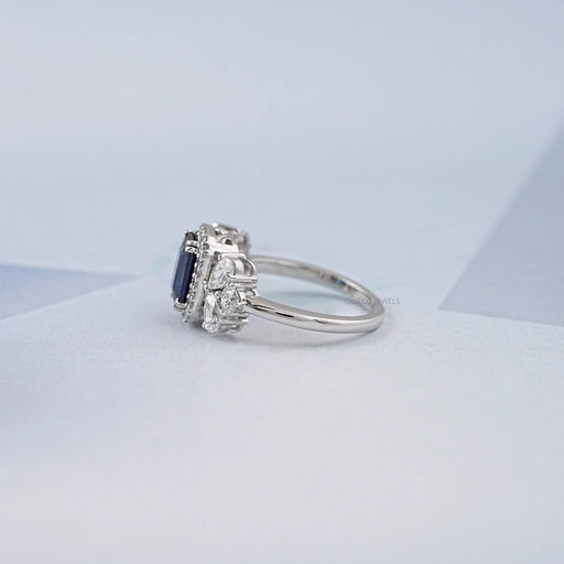 blue sapphire emerald diamond engagement ring  with halo accent's side view