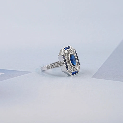 blue oval and baguette cut halo gemstone engagement ring's side view