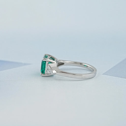 side view of asscher cut green gemstone with bullet diamond 3 stone wedding ring