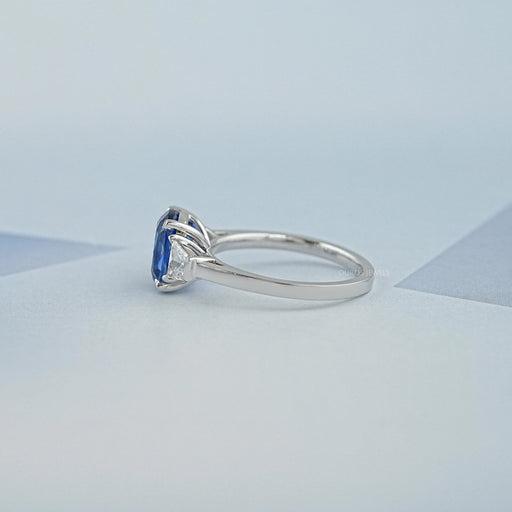 side view of sapphire cushion gemstone with trapezoid diamond 3 stone wedding ring