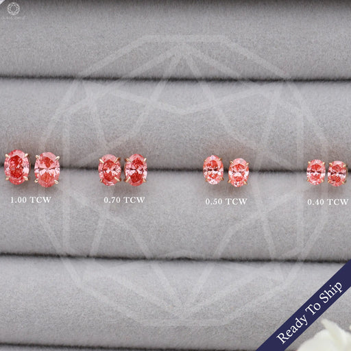 front view of pink oval cut lab grown diamond screw back earrings on box