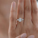 elongated cushion and baguette cut diamond five stone wedding ring in finger