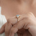 blue hexagon-cut lab diamond halo 3-stone colored engagement ring on model's finger