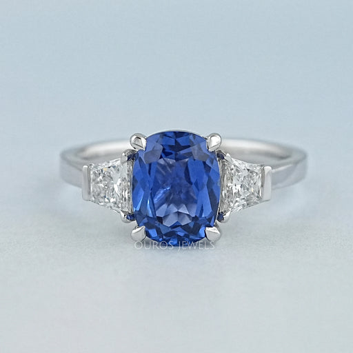 front view of sapphire cushion gemstone with trapezoid diamond 3 stone wedding ring