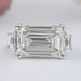 front view of east west emerald step cut trapezoid diamond three stone ring