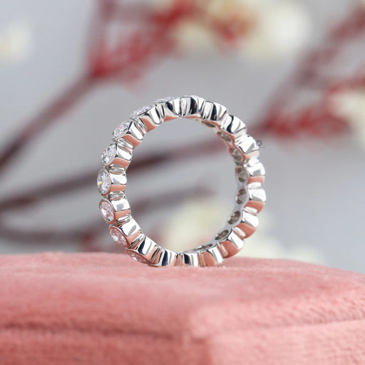 side view of oval cut lab created diamond bezel eternity band white gold