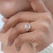 emerald-cut lab diamond half bezel set solitaire engagement ring on model's finger