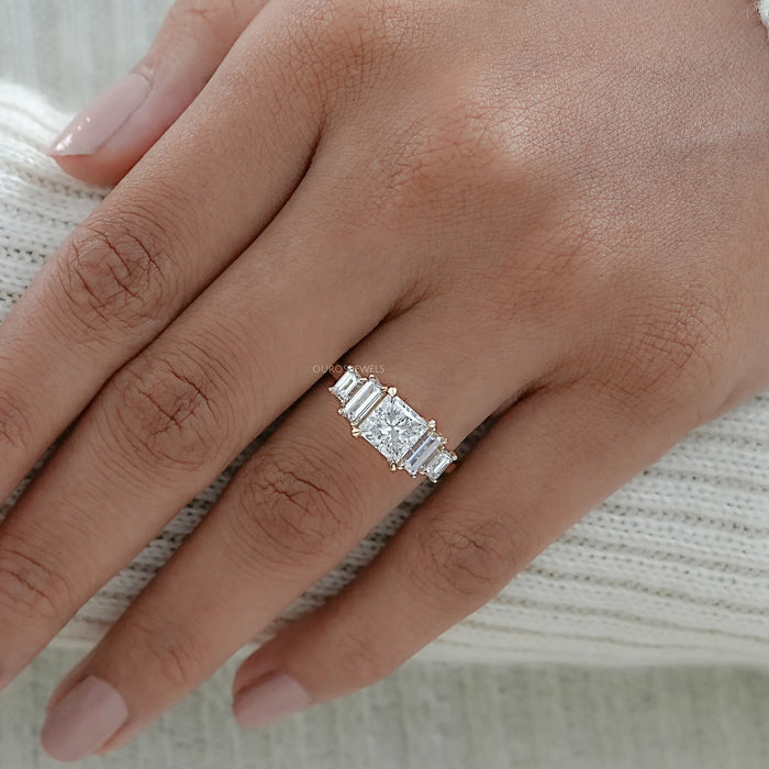 princess and baguette cut lab diamond five stone engagement ring on model's finger