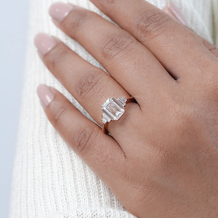 emerald-cut lab diamond half bezel set solitaire engagement ring in finger