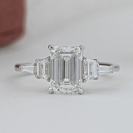 front view of emerald cut and trapezoid lab diamond five stone engagement ring