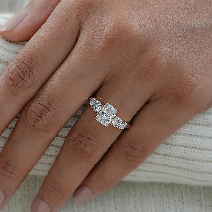 radiant cut lab grown diamond five stone engagement ring on model's finger