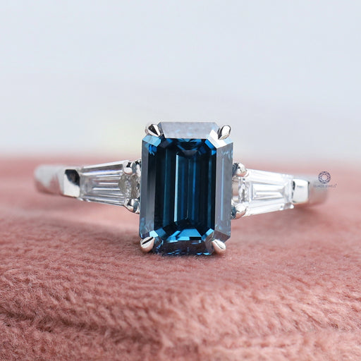 front view of blue emerald cut lab diamond three stone engagement ring