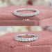 The two close-up images of Round Cut Lab Diamond Eternity Wedding Band. The first band has diamonds measuring 2.10 MM, and the second band has diamonds measuring 2.70 MM, both placed on a soft pink fabric background.