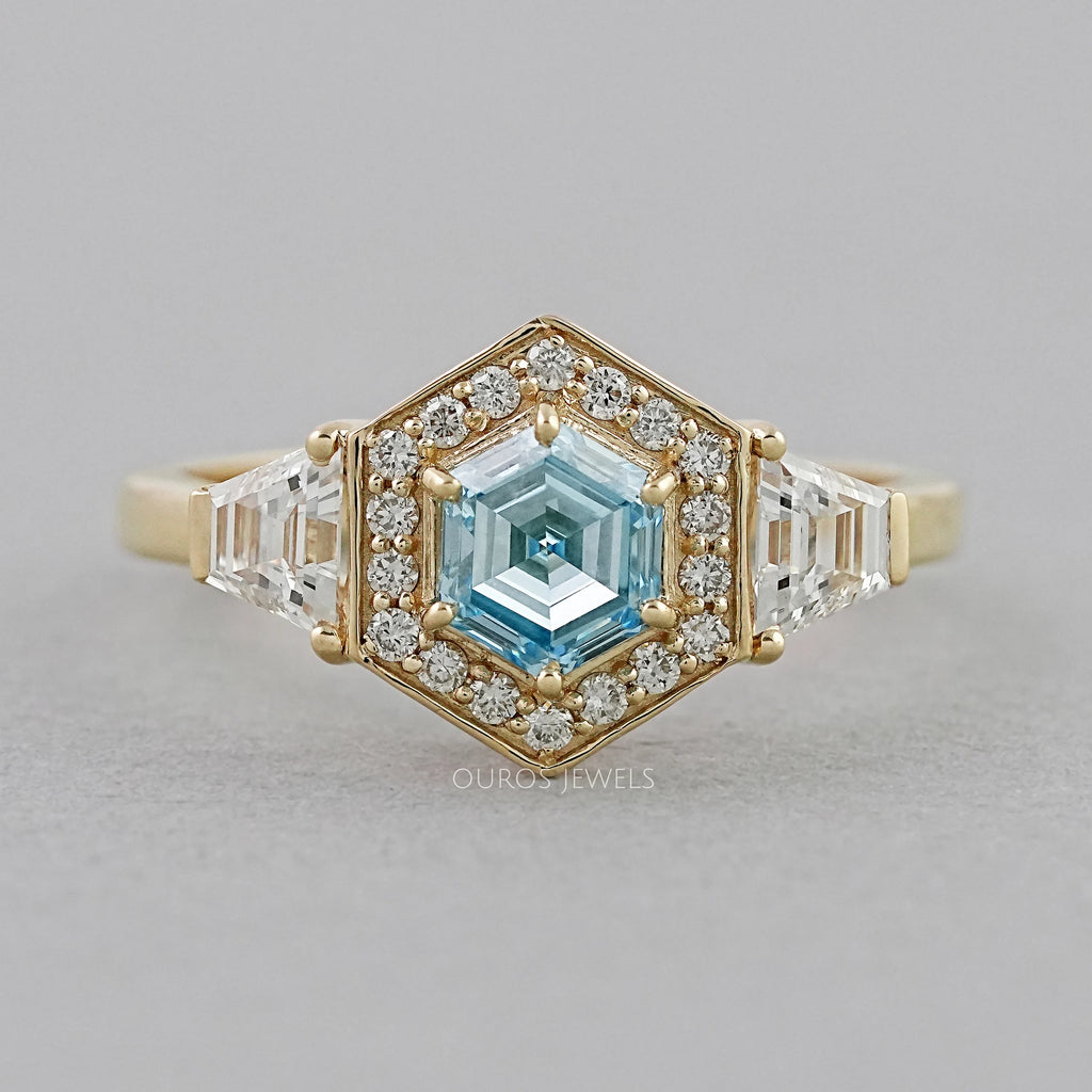 front view of blue hexagon-cut lab diamond halo 3-stone colored engagement ring