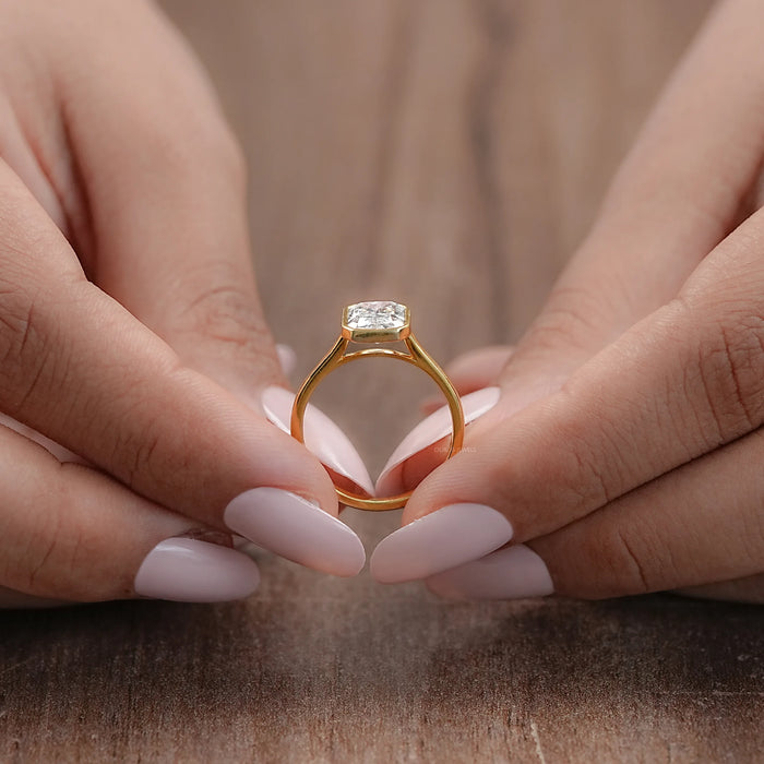 close up view of radiant cut diamond bezel set solitaire engagement ring