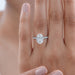 oval cut lab-grown diamond hidden halo solitaire engagement ring on model's finger
