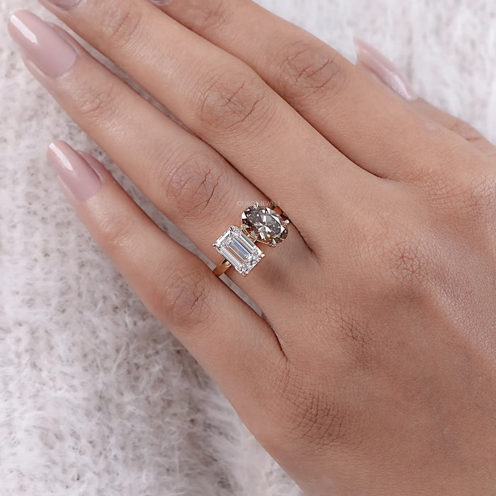 emerald and champagne oval-cut lab diamond toi et moi engagement ring in finger