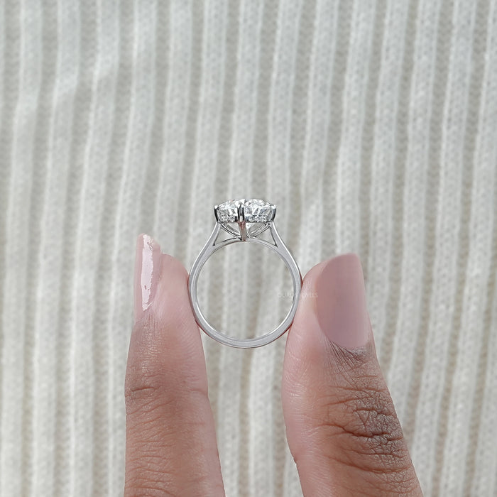 close up with side view of 3 carat oval cut diamond hidden halo engagement ring