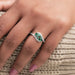 green round gemstone cluster bypass engagement ring in finger