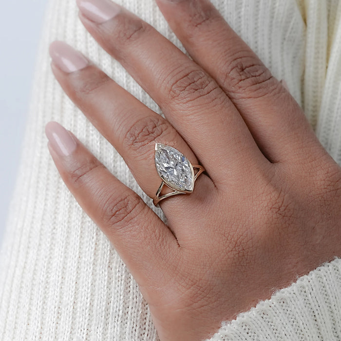 marquise diamond bezel set split shank band engagement ring worn on finger