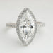 front view of marquise cut lab diamond halo engagement ring on grey fabric