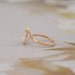 side view of old mine moval double prong engagement ring in yellow gold band