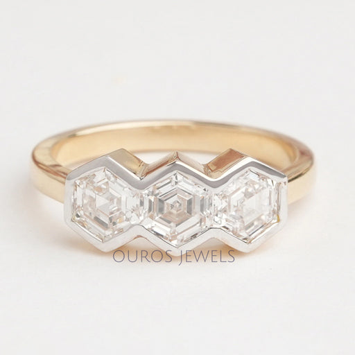 front view of three stone hexagon cut diamond bezel set engagement ring