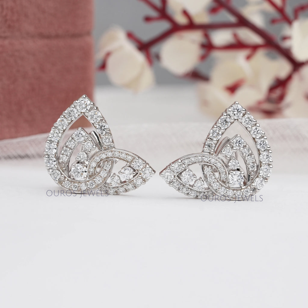 front view of round cluster diamond pear shaped clip on earrings white gold