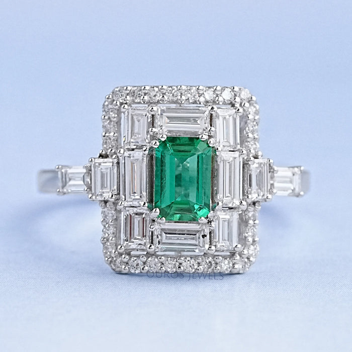 top view of green emerald baguette & round diamond halo gemstone engagement ring