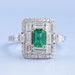 top view of green emerald baguette & round diamond halo gemstone engagement ring