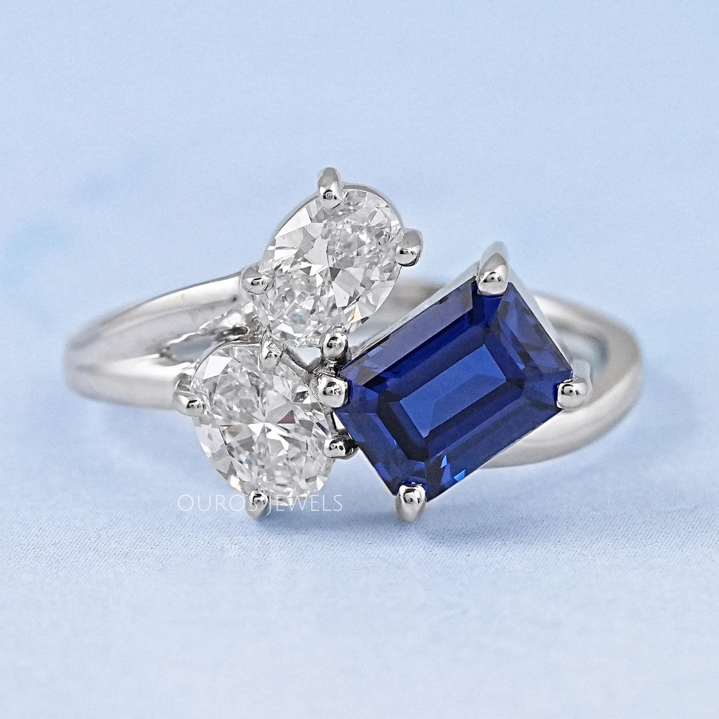 front view of sapphire emerald and oval cut diamond split shank engagement ring
