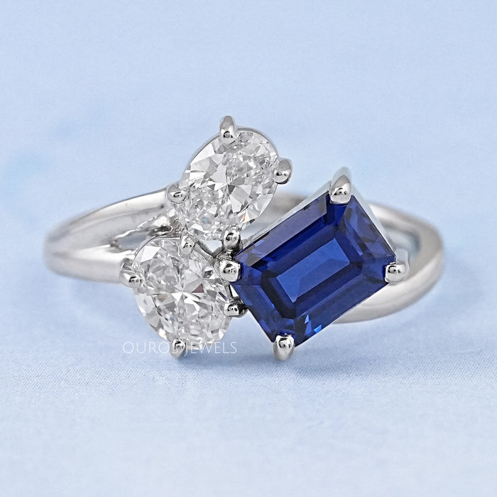 front view of sapphire emerald and oval cut diamond split shank engagement ring