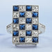 front view of sapphire and french cut lab diamond vintage engagement ring on fabric
