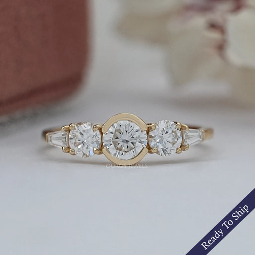 top view of round and tapered baguette diamond half bezel five stone engagement ring