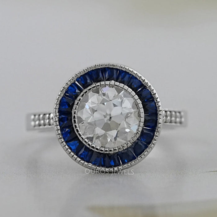 OEC round diamond surround with sapphire baguette halo wedding ring's front view