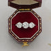 old european round cut lab diamond three stone engagement ring in jewelry box