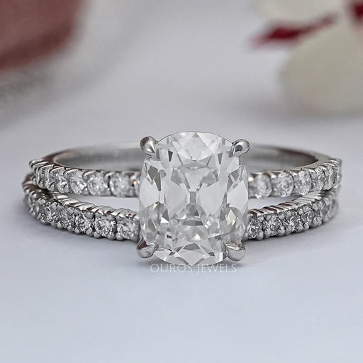 front view of old mine cushion-cut lab diamond bridal ring set on grey fabric