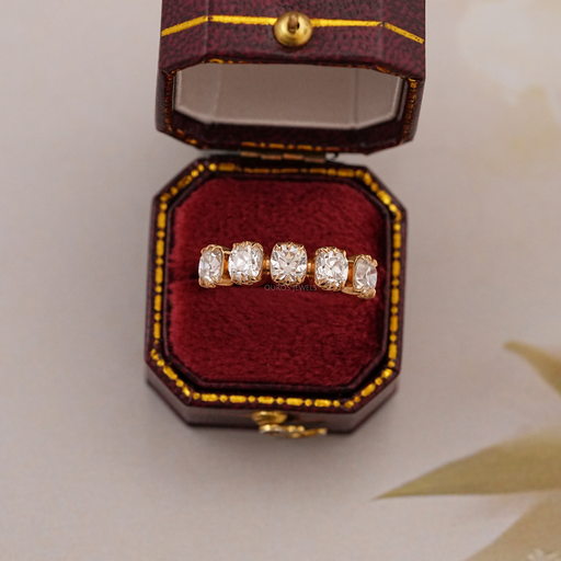 old mine cushion cut five stone wedding ring with yellow gold band in jewelry box