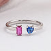 front view of pink emerald and blue heart gemstone open wedding band