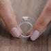 close view of oval-cut lab-grown diamond hidden halo solitaire engagement ring