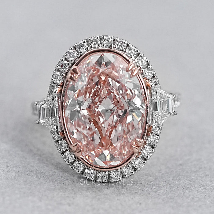 front view of pink oval diamond with trapezoid accent halo diamond ring