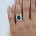 sapphire oval cut gemstone halo split shank engagement ring in finger