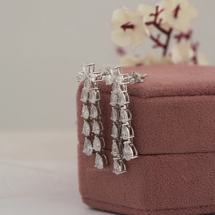 side view of pear shaped man made diamond basket setting dangle drop earrings