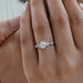 round and pear cut lab diamond five stone engagement ring on model's finger