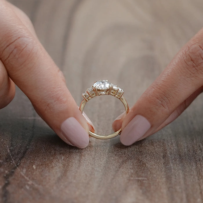 close view of pear and baguette cut lab diamond five stone engagement ring